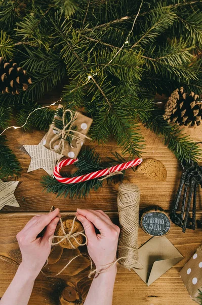 Kvinnliga händer som förbereder sig för jul. Julpyssel, kottar — Stockfoto