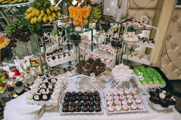 Various colored delicious sweets in a candy bar at a wedding. Sweet table. Wedding buffet. — Stock Photo, Image