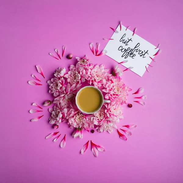 Card with inscription but first coffee, coffee in a cup with chrysanthemum flowers around it. — Stock Photo, Image