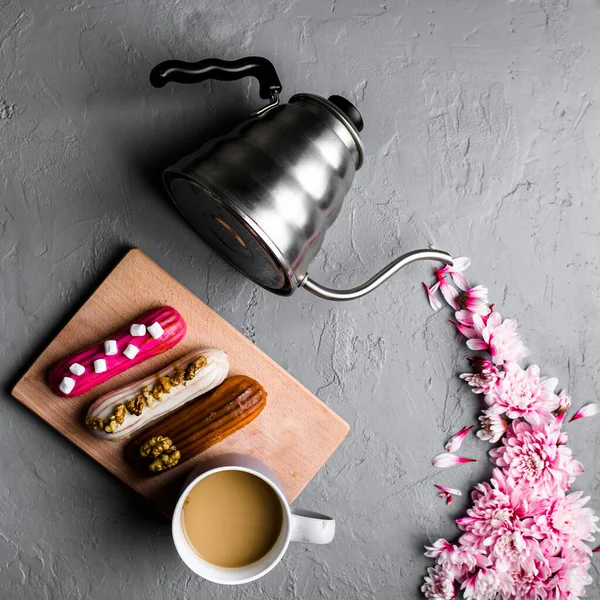 Creative layout of teapot with chrysanthemum flowers on gray concrete background texture. — Stock Photo, Image