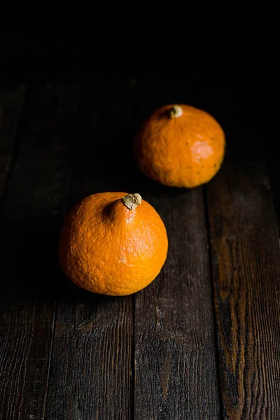 Orange pumpkins on dark wooden background — Stock Photo, Image