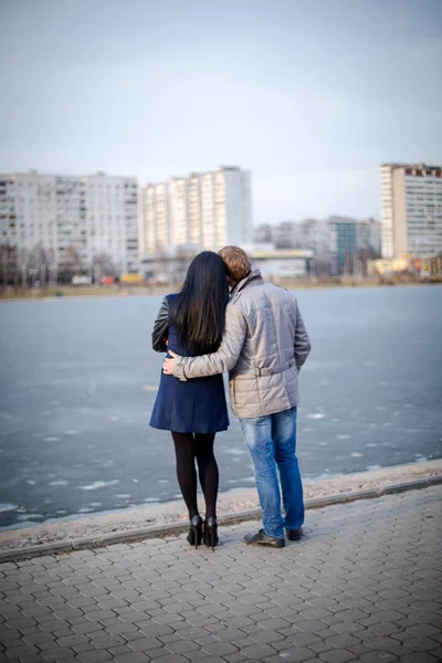 Beloved young people are walking outdoor. Autumn pond in the city. Urban style.