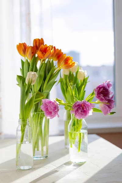 Two vases of spring tulips on the table Stock Image