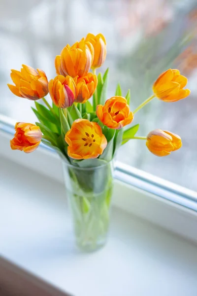 Spring tulips  in a vase near the window — Stock Photo, Image