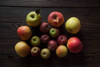 Grup farklı boyutlarda bir ahşap yüzeye renkli elma