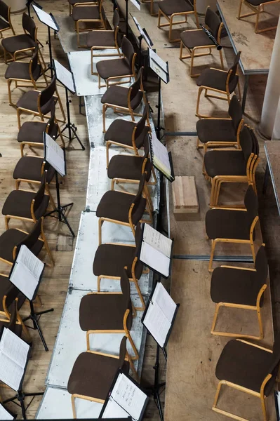 Empty stage with chairs and music stands before the concert. Arranged in a semicircle. Top view