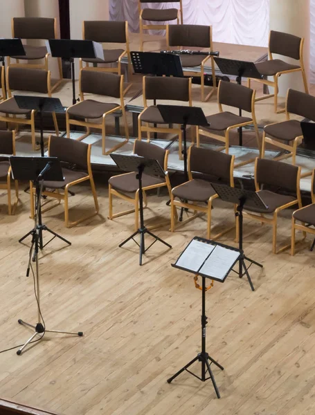Empty stage with chairs, microphones and music stands before the concert. Top view