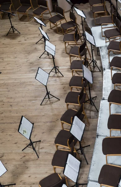 Empty stage with chairs and music stands before the concert. Arranged in a semicircle. Top view