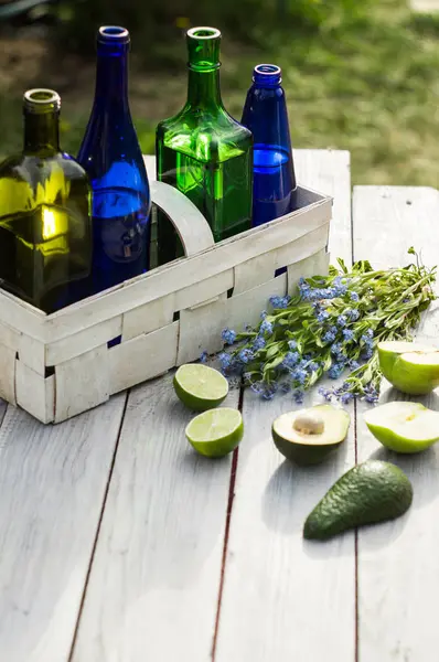 Four Bottles Drinks White Basket Fruits White Table — Stock Photo, Image