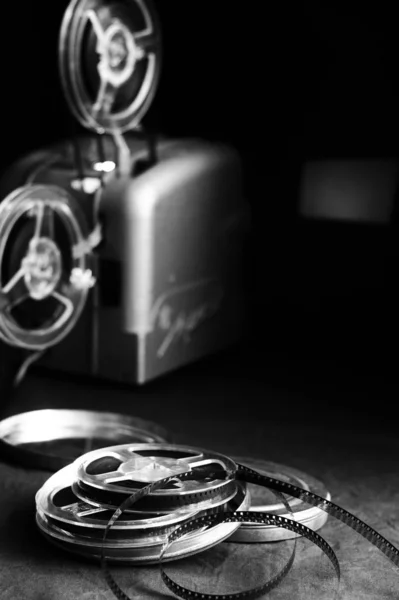 Old cinema projector and cassettes in the dark