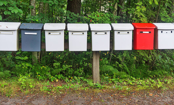 Row multicolored postboxes in the park