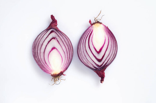 Red onion cut in half on a white background