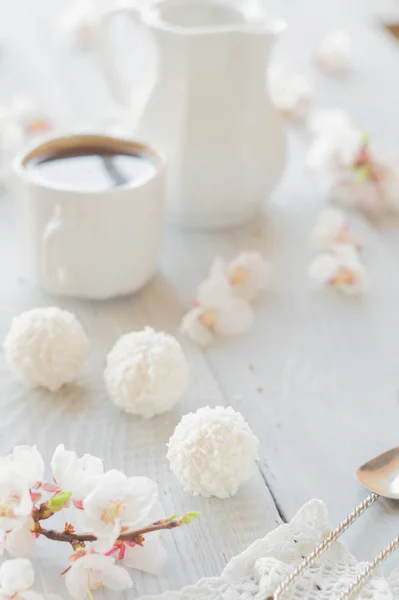 Tasse de café, de lait et de branche d'abricot en fleurs sur bois blanc — Photo