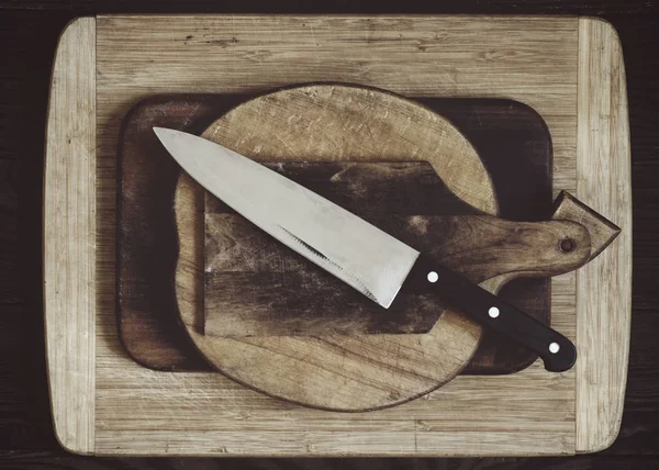 Various wooden cutting boards and kitchen knife