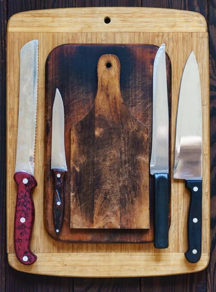 Wooden cutting boards and various kitchen knives