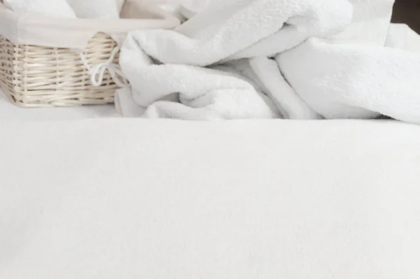 Beauty studio blurred background. White towel, basket and cream — Stock Photo, Image