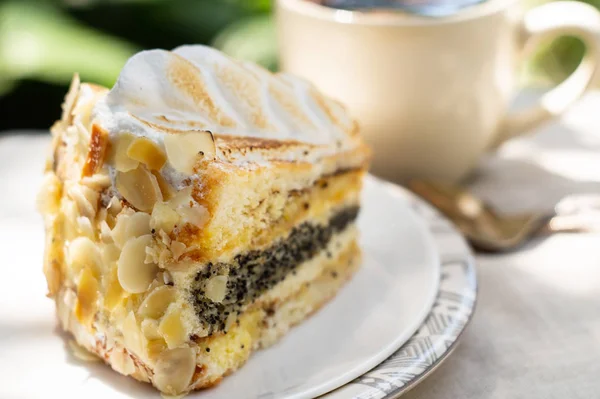 Almond cake with cream and a cup of coffee