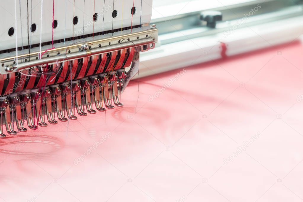 Industrial embroidery machine in textile production workshop