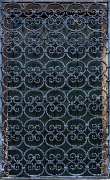 Forged old curly metal grid on the window — Stock Photo, Image