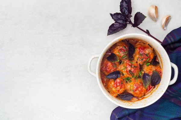 stock image Meatballs stewed in tomato sauce in a saucepan with basil and garlic