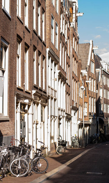 Bicycles parked near the wall of an old building in Amsterdam, Netherlands