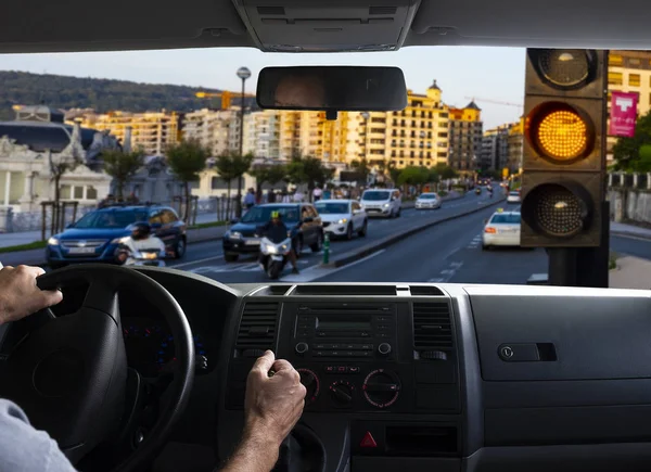 Inside car view of a orange traffic light