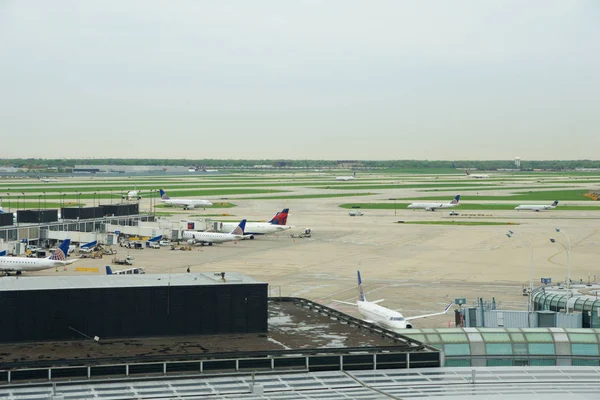 Chicago, Illinois, USA - 11 maj 2018: flera flygbolag jet parkering vid gate position på den internationella flygplatsen Chicago Ohare på morgonen — Stockfoto