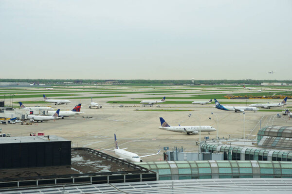 CHICAGO, ILLINOIS, UNITED STATES - MAY 11th, 2018: Several Airlines jet parking on gate position at Chicago OHare International Airport in the morning