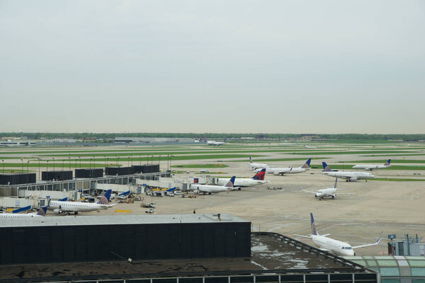 CHICAGO, ILLINOIS, UNITED STATES - MAY 11th, 2018: Several Airlines jet parking on gate position at Chicago OHare International Airport in the morning