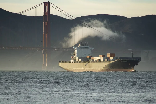 SAN FRANCISCO, CALIFORNIA, ESTADOS UNIDOS - 25 DE NOV DE 2018: Un buque portacontenedores de carga en movimiento rápido, que entra en la bahía de San Francisco, navegando por debajo del puente Golden Gate —  Fotos de Stock