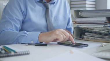 Muhasebe Arşiv Dairesi içinde Smartphone kullanarak işadamı görüntü metin