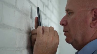 İşadamı bir duvar okuma yakınındaki bir kötü mesaj cep telefonuyla hayal kırıklığına