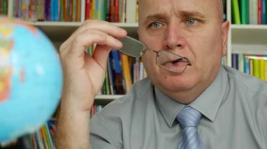 Adam gözlük ile oynayan ve bir seyahat planlıyorsanız Earth harita için arıyor