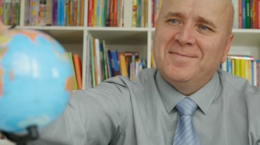 Ağır çekim bir mutlu bir adam çalışma dünya küre ve yapmak Ok el hareketleri ile