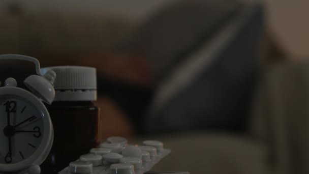 Man Sleeping Sofa Looking Alarm Clock Some Medicine Pills — Stok Video