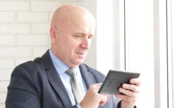 İşadamı kullanım mobil Online bağlantı iletilerini okuyabilir ve memnuniyet gülümseme