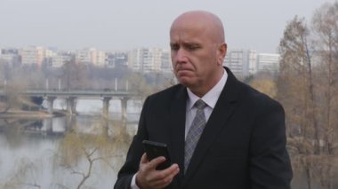 Ağır çekim işadamı mobil kontrol kol saati için hayal kırıklığına arıyorsunuz