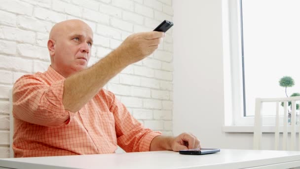 Relaxed Man Changing TV Channels with Infrared Remote (Ultra High Definition, UltraHD, Ultra HD, UHD, 4K, 3840x2160) — Stock Video