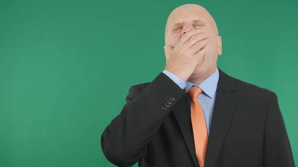Уставший бизнесмен зевает с зеленым экраном на заднем плане — стоковое фото