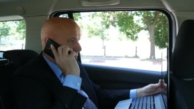 Yöneticisi çalışma içinde taksi taksi Talk dizüstü kullanarak cep telefonu için iletileri yazma