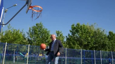 Sepet halkada çekim eğlence basketbol oynarken işadamı