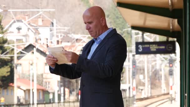 Impatient Businessman Traveler Reading Newspaper Waiting Train Transportation — Stock Video