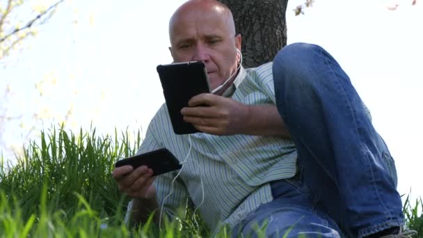 Pessoa Relaxada Usando Fones Ouvido Móveis Toque Tablet Desfrutando Aplicativos — Vídeo de Stock