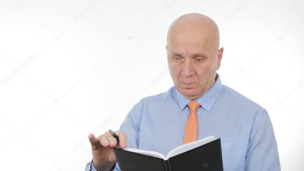 Businessman Image Reading and Writing in Agenda