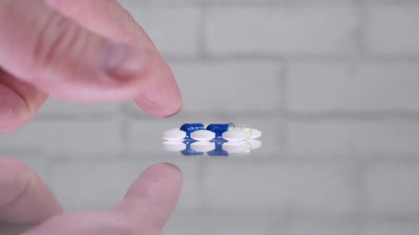 Man Hand Choosing Some Colored Medical Pills Transparent Table — Stock Video