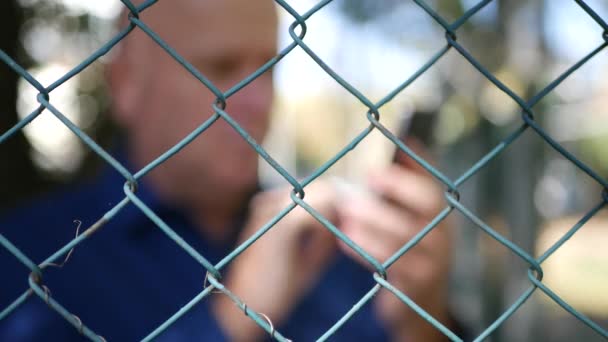 Blurred Image Astonished Man Metallic Fence Read Bad News Mobile — Stock Video