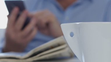 Bir cep telefonu kablosuz bağlantı kullanarak işadamının el manifatura kadar kapatın