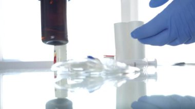 Doktor Hands eldiven giyiyor dezenfektan çözeltisi ile bir tıp şişesi kontrol