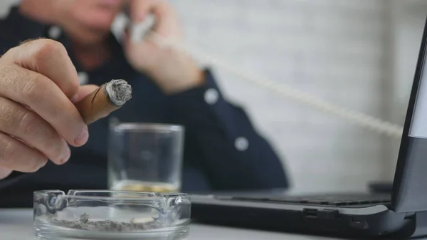 Businessman Smoke a Cigar in Office and Talk to Telephone