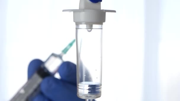 Perfusion Installation in Foreground Man Hands Using a Syringe in Background — Stock Video